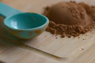Measuring spoon next to cocoa powder