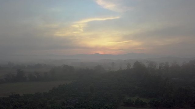 Raising up looking over farming fields at the most beautiful morning sunrise in Chiang Rai Thailand