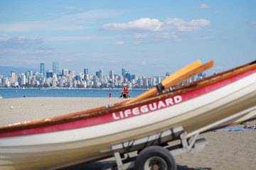 A female lifeguard watches over swimmers at Locarno beach, Vancouver. (face blurred out)