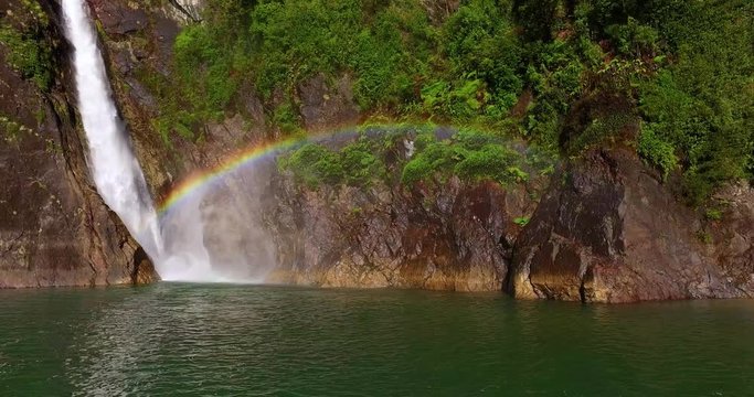 Aerial view of the Velo de la Novia waterfall that flows into Lake Tagua Tagua, surrounded by native forest