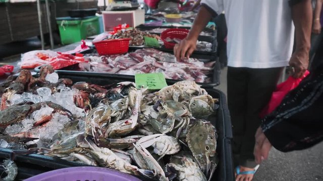 People choosing seafood at the weekend market in Malaysia