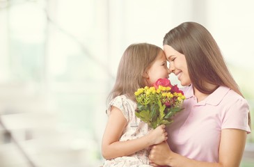 Fototapeta na wymiar Happy Mother and daughter together with flowers