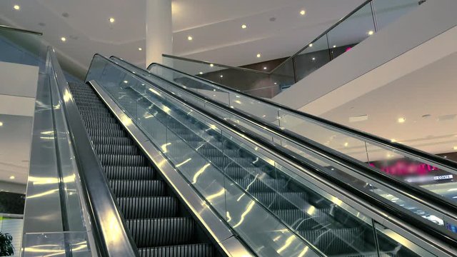 Escalator in mall going oposite directions. No riders. Closeup in 4k 30fps.mov