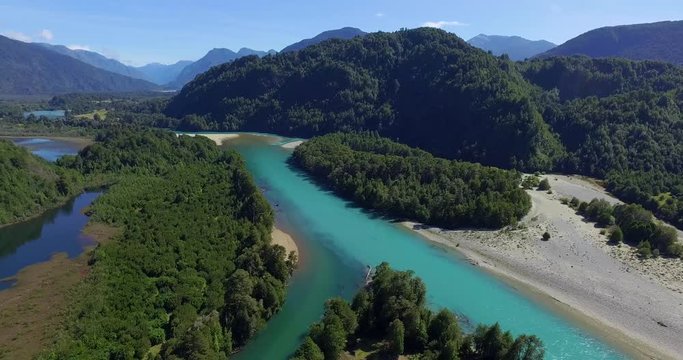 Aerial view at low altitude of the Traidor River surrounded by native and pristine forest, Chilean Patagonia
