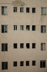 Obraz premium close up to a building, pattern of windows of a gray building