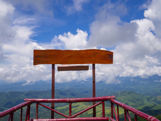 Blank of wooden billboard for advertisement with moutains and sky cloudy background.