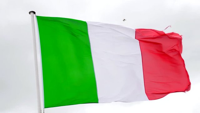 Italian flag fluttering in the wind with a white background
