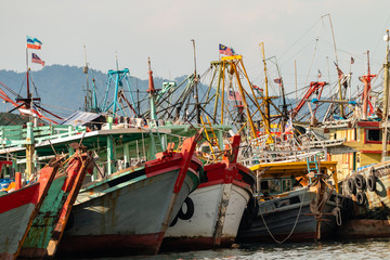 Obraz na płótnie Canvas A fleet of fishing boats moored at port in Asia
