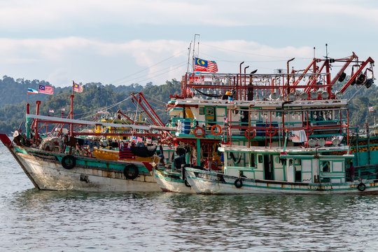 A fleet of fishing boats moored at port in Asia