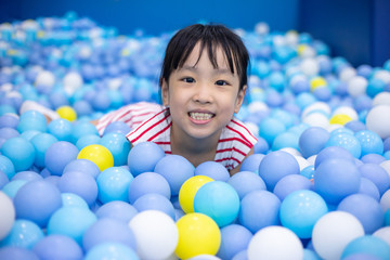 Fototapeta na wymiar Asian Chinese little Girl Playing At Balls Pool