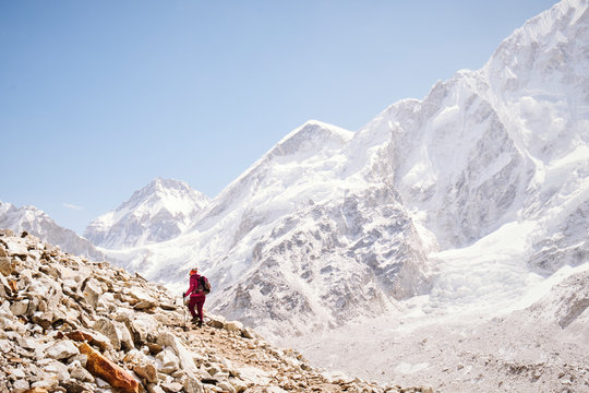 A woman hikes alongside the Khumbu Glacier in the Himalayas