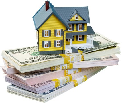 Model Of A House On A Stack Of Money - Isolated