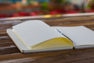 Book open  and pen on wood background. Top view.Vintage style.