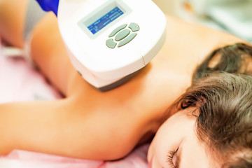 Woman gets anti-cellulite and anti-fat therapy in beauty salon