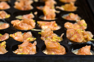 Close up baking prawns in baking pan with holes