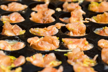 Close up baking prawns in baking pan with holes