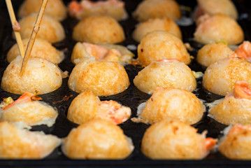 Close up baking prawns in baking pan with holes