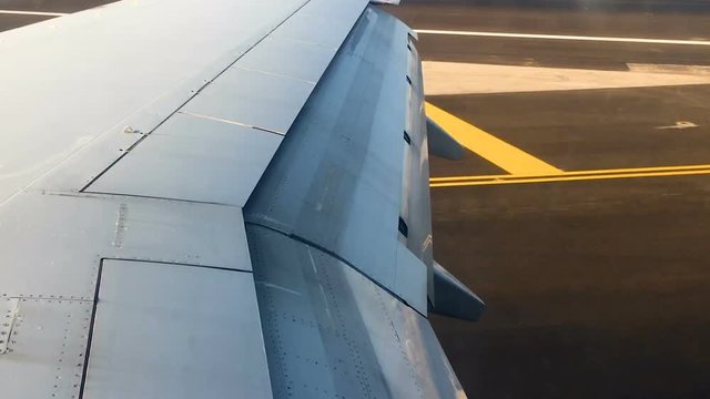 Aircraft airplane wings during landing on port. Wings take of Ground spoiler and lift flups