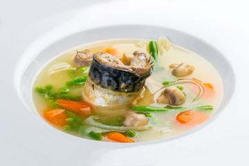 Fish soup with mackerel and vegetables. On a white background