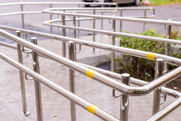 Fototapeta na wymiar wheelchair entry, outdoor object, nobody.Way of wheelchair, concrete ramp way with stainless steel handrail with disabled sign on the floor for support wheelchair of disabled people.Selective focus