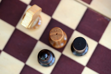 Chess figures on a chessboard close up. Top view