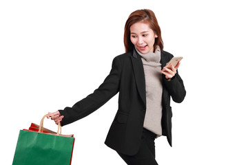 shopping woman holding shopping bags and cell phone isolated on white background