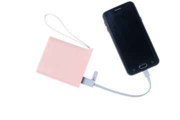 Modern smartphone charging from power bank isolated on white background. Gadgets for smartphones,...