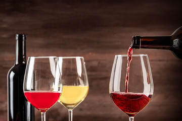 Red wine poured into glass from bottle with a place for text
