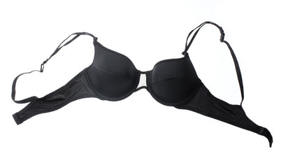 Black female bra hanging on a clothesline with buckles isolated on white background.