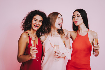 Three Emotional Women in Dresses with Champagne.