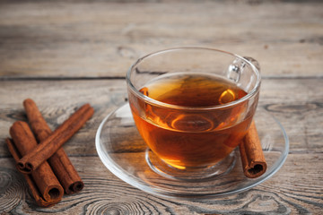 aromatic hot cinnamon tea on wooden table