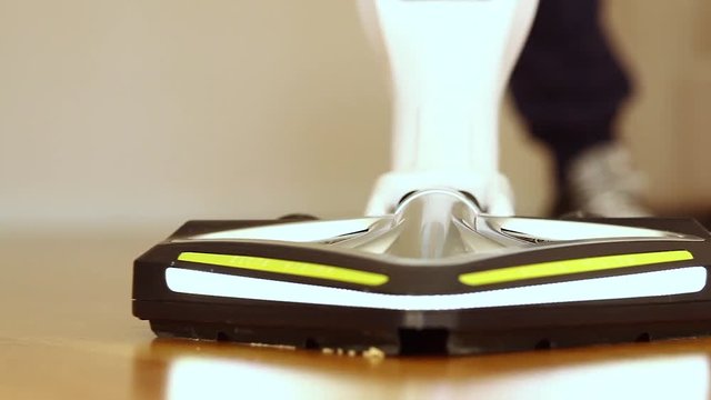 Vacuum cleaner with led light used on the floor in oak parquet.