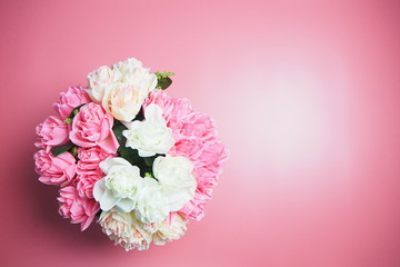 Fototapeta premium Rose flowers are on a pink background. Valentines Day Background.