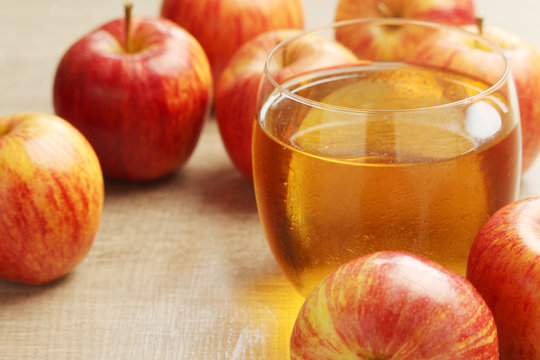 A glass with juice and apples