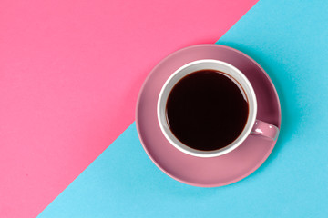 cup of coffee and saucer on color background
