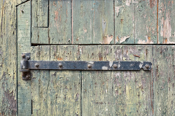 Old door with rusty hinge.
