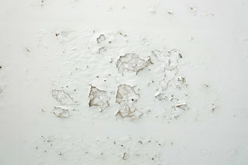 Closeup of peeling painted white wall