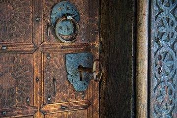 Big key in rustic door of wooden church