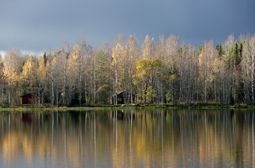 Fototapeta premium Dark clouds over the tranquil river landscape. 