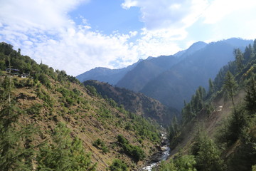 Fototapeta na wymiar Small River Passing Through Between The Mountains