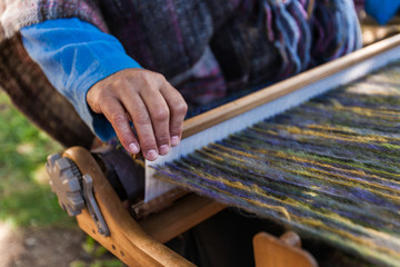 Man is weaving very fancy multi colored wool using a wooden loom - 1/6 - Closeup picture showing the different colors of the wool