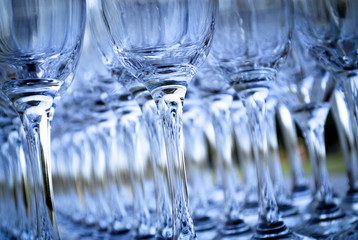 Fototapeta na wymiar Empty wine glasses in abstract blue.