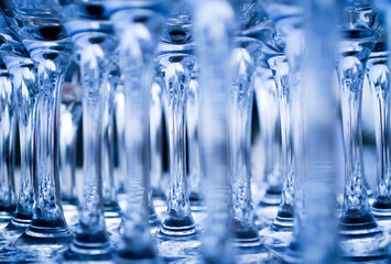 Fototapeta na wymiar Empty wine glasses in abstract blue.
