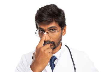 Doctor fixing spectacles with finger.