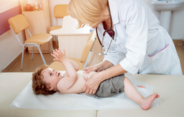 Friendly doctor pediatrician with patient child at clinic