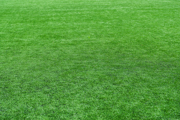 Photo of the details of football field with artificial grass.