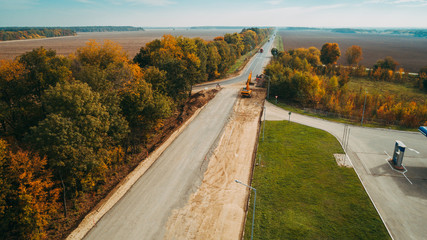 Aerial view of the road construction process. Autumn.