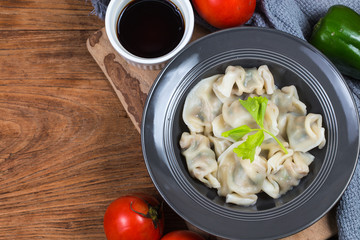 Asian dumplings in bowl, chopsticks, Chinese dumplings for dinner.Chinese dumplings for dinner/lunch. Traditional Asian/Chinese cuisine.