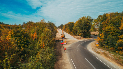 Aerial view of the road construction process. Autumn.