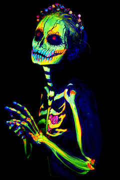 UV body art painting of helloween female skeleton Día de los Muertos